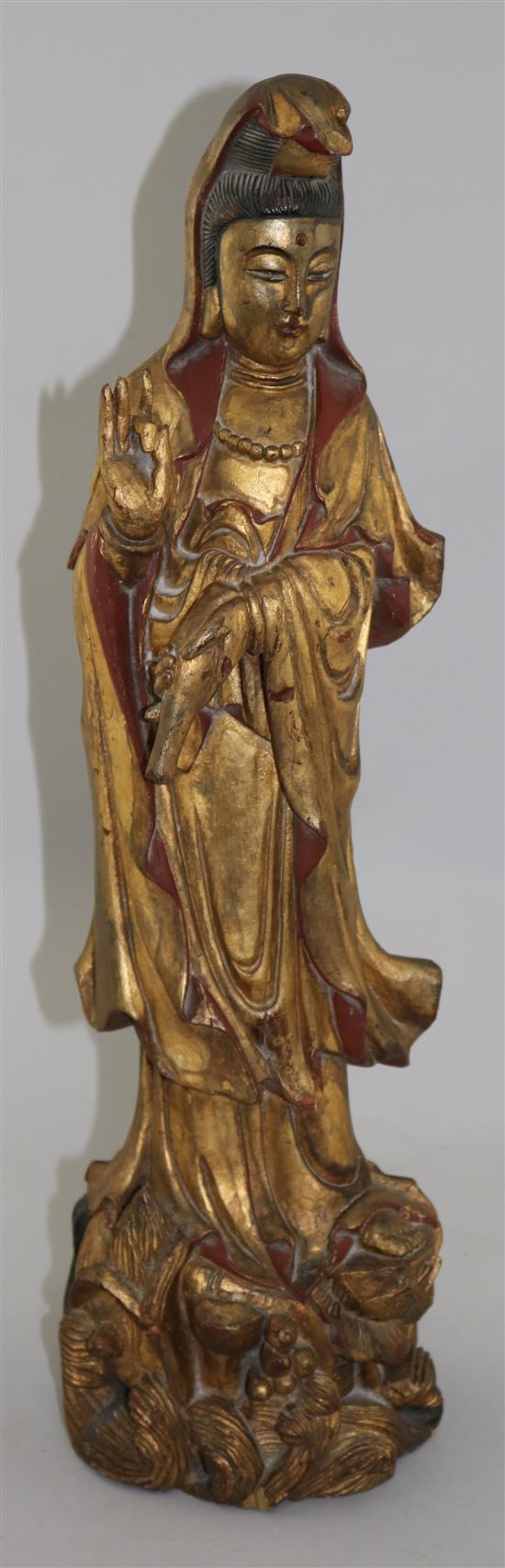 A late 19th century Chinese carved and giltwood figure of Guanyin, 20in.